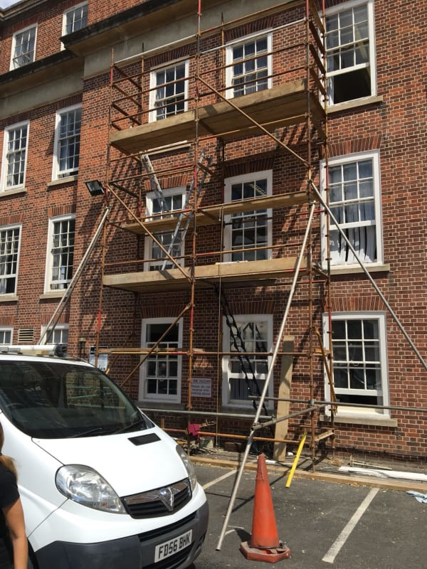 Painting exterior woodwork on block of flats in Worcester.